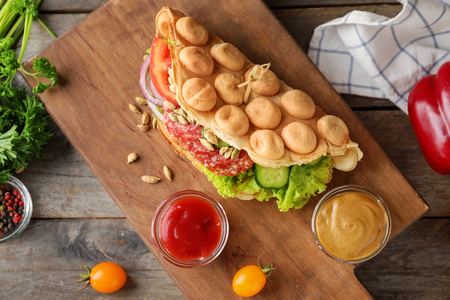 Delicious bubble waffle with sauces on wooden boardの写真素材