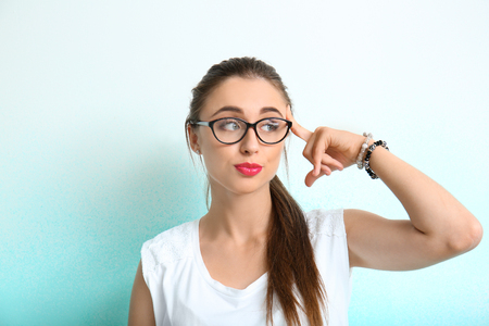 Emotional young woman on color backgroundの写真素材