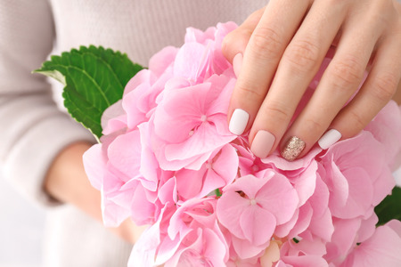 Woman holding beautiful pink flowers, closeupの写真素材