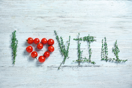 Text I LOVE YOU made of thyme twigs and tomatoes on wooden backgroundの写真素材