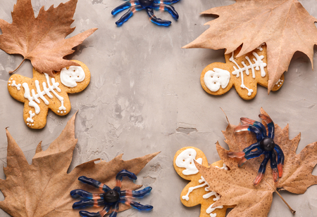 Creative Halloween cookies, candies and dry leaves on grey backgroundの写真素材