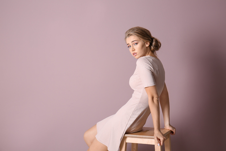 Portrait of beautiful young woman on color backgroundの写真素材