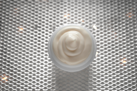Jar with body cream on shiny gridの写真素材