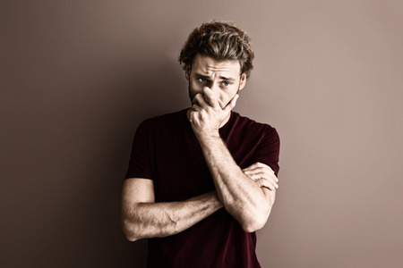 Portrait of handsome man on color background with sepia effectの写真素材