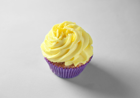 Delicious lemon cupcake on light backgroundの写真素材