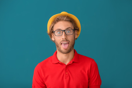 Funny handsome man on color backgroundの写真素材