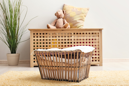 Laundry basket with folded clean towels on floorの写真素材