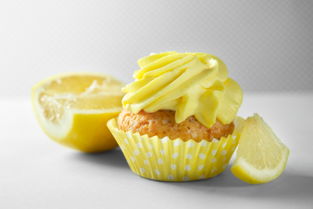 Delicious lemon cupcake on light backgroundの写真素材