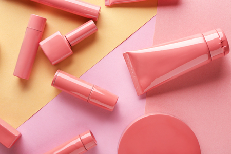 Set of pink decorative cosmetics on color backgroundの写真素材