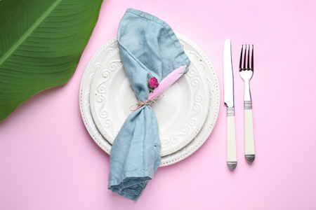 Table setting with tropical leaf on color backgroundの写真素材