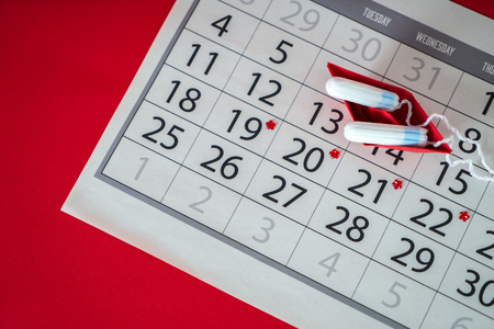 Tampons with red origami boat on calendarの写真素材