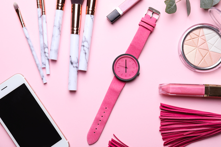 Decorative cosmetics with mobile phone and accessories on color backgroundの写真素材