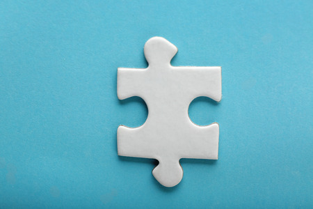 Piece of jigsaw puzzle on color backgroundの写真素材