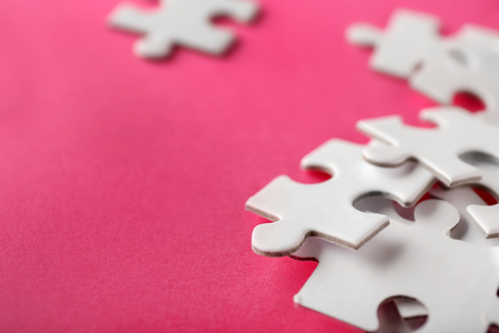 Pieces of jigsaw puzzle on color background, closeupの写真素材