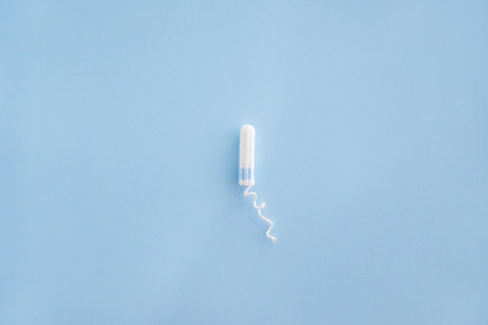 Tampon on color background