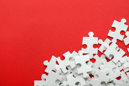 Pieces of jigsaw puzzle on color backgroundの写真素材