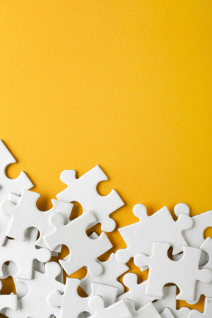 Pieces of jigsaw puzzle on color backgroundの写真素材