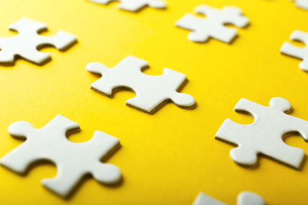 Pieces of jigsaw puzzle on color backgroundの写真素材