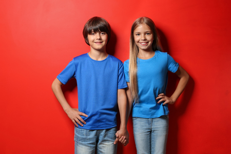 Boy and girl in t-shirts on color backgroundの写真素材