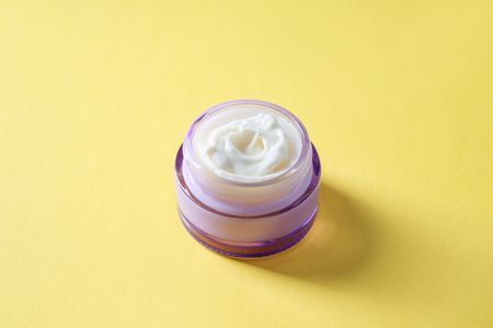 Jar with body cream on color backgroundの写真素材