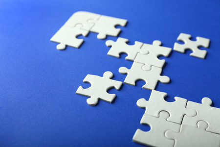 Incomplete jigsaw puzzle on color backgroundの写真素材