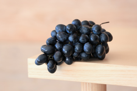 Ripe sweet grapes on wooden tableの写真素材