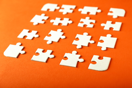 Pieces of jigsaw puzzle on color backgroundの写真素材