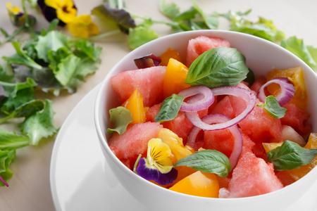 Bowl with delicious watermelon salad on plateの写真素材