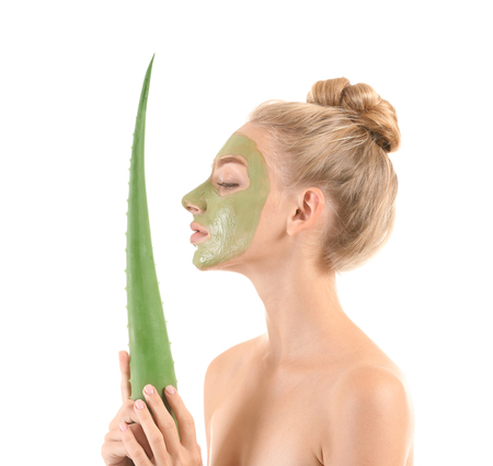 Beautiful young woman with facial mask containing aloe vera extract, on white backgroundの写真素材
