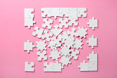 Incomplete jigsaw puzzle on color backgroundの写真素材