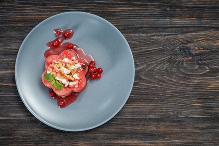 Plate with delicious watermelon salad on wooden table, top viewの写真素材