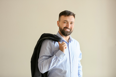 Portrait of handsome businessman on light backgroundの写真素材