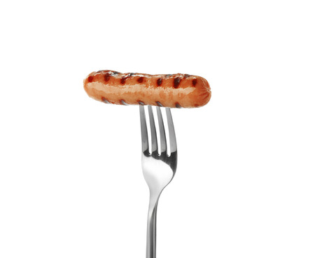Fork with delicious grilled sausage on white backgroundの写真素材