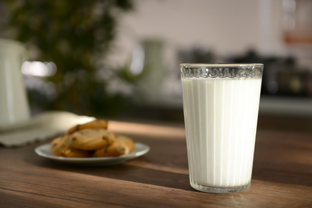 Full glass of fresh milk on wooden tableの写真素材
