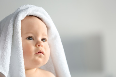 Cute little baby with soft towel at homeの写真素材