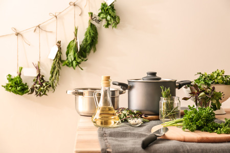 Fresh aromatic herbs with spices and oil on kitchen tableの写真素材