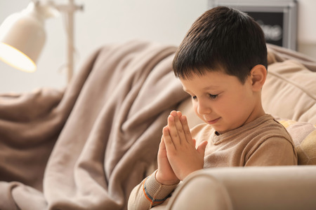 Little boy praying at homeの写真素材
