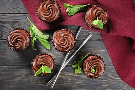 Delicious chocolate cupcakes on wooden tableの写真素材