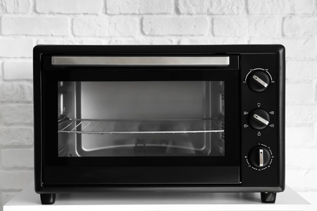 Modern electric oven on white table  in kitchen