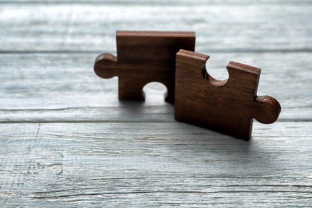 Pieces of puzzle on wooden backgroundの写真素材