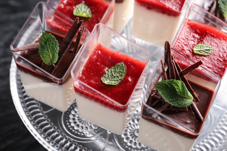 Glasses with tasty panna cotta on stand, closeupの写真素材