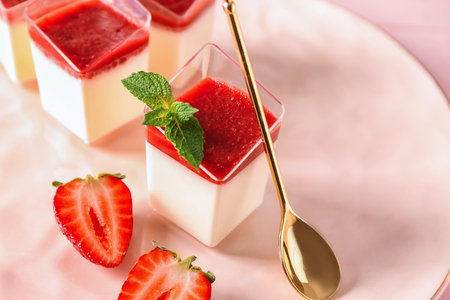 Glasses with tasty strawberry panna cotta on plate, closeupの写真素材