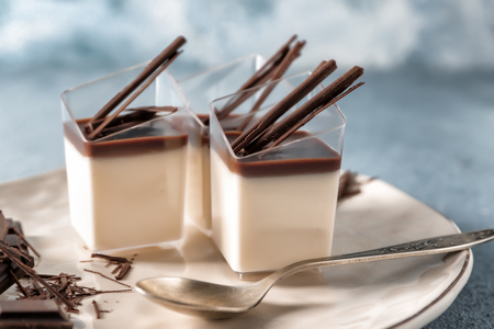 Glasses with tasty chocolate panna cotta on plate, closeupの写真素材