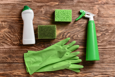 Cleaning supplies on wooden backgroundの写真素材