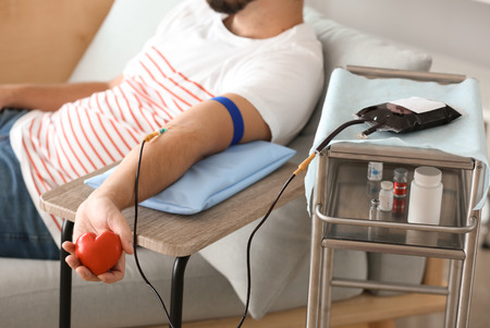 Man donating blood in hospitalの写真素材