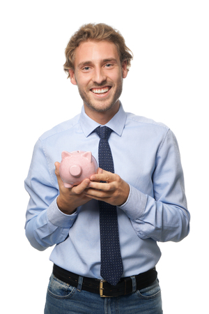 Handsome man with piggy bank on white backgroundの写真素材