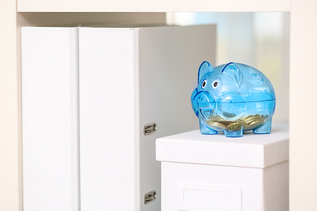 Cute piggy bank with coins on white boxの写真素材