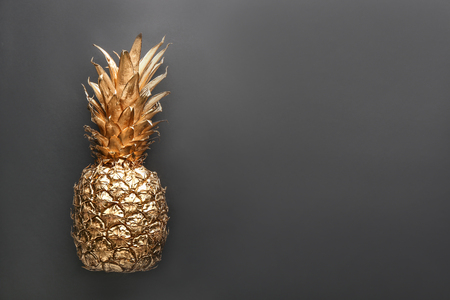 Golden pineapple on black backgroundの写真素材