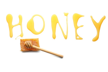 Word HONEY and wooden dipper on white backgroundの写真素材
