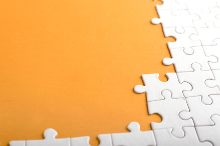 Incomplete jigsaw puzzle on color backgroundの写真素材
